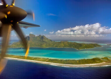 Bora Bora island and airplane propeller as seen when landing on small plane