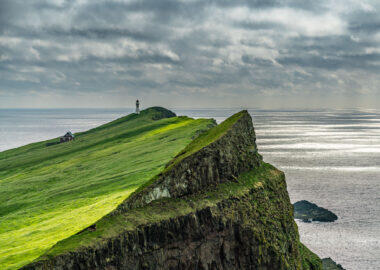 The lighthouse on Mykines island under the clouds, Faroe Islands