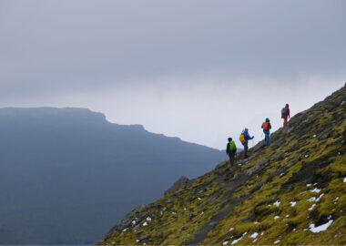 Silhouette of hiking people during mountain trip to highest peak