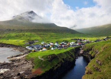 Village of Gjogv on Faroe Islands with colourful houses. Mountain landscape with ocean coast